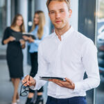 three collegues working at a car showroom